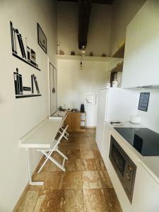 a small kitchen with a table and a desk at La dogana in Siena