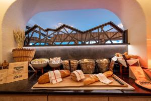 a counter with a tray of bread and a bridge at Hotel Kreuz & Post Grindelwald in Grindelwald +229 photos