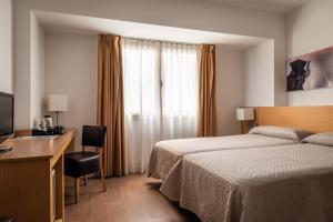 Postel nebo postele na pokoji v ubytování Hotel Sagrada Familia
