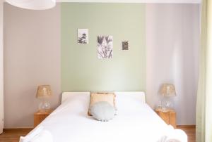a bedroom with a white bed with two lamps at Le Luminosa - Centre Ville - 6 pers in Haguenau +17 photos