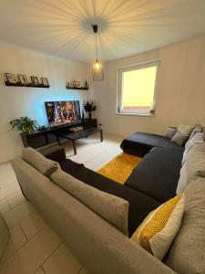 a living room with a couch and a tv at 3izbový rodinný dom s krbom in Ružomberok