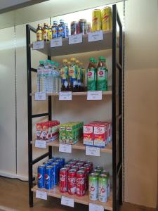 a shelf full of soda bottles in a store at Fortune Hotel Korat- SHA Plus in Nakhon Ratchasima +79 photos