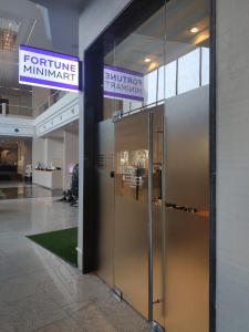 an entrance to a building with a large metal elevator at Fortune Hotel Korat- SHA Plus in Nakhon Ratchasima