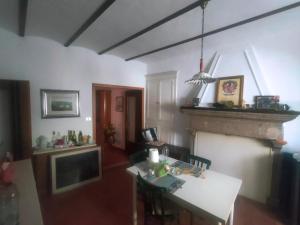 a living room with a table and a fireplace at Vannelli Rooms in Castelbottaccio