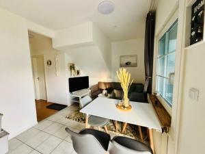 a living room with a white table and chairs at Ferienhaus Usedom Familie Stopp Haus 21 in Lütow +10 photos