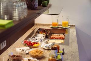 a buffet with food and drinks on a counter at Gästehaus Schlegel in Kernen