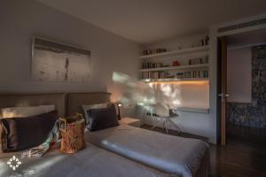 a bedroom with a bed and a book shelf at Villa EL Azahar by Abahana Luxe in Altea la Vieja