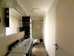 a bathroom with a white sink and a toilet at Charming Apartment Angela near Malinska in Sveti Anton