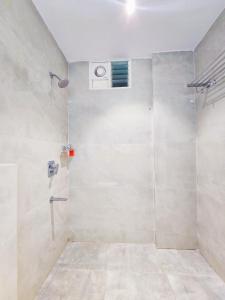 a bathroom with a shower with a window at Hotel Lemon Park in Visakhapatnam +21 photos