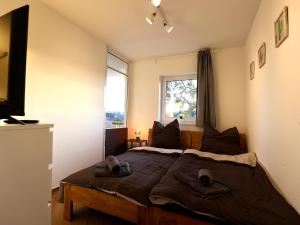 a bedroom with a large bed and a window at Modern Apartment Near Kristalltherme- MontiRooms in Ludwigsfelde