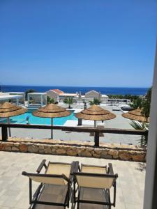 a view of a patio with chairs and umbrellas at Althea Boutique Hotel - Adults Only in Amoopi