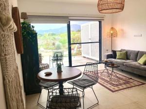 a living room with a table and chairs and a couch at Retreat, block B2, unit 6 in Ayios Nikolaos