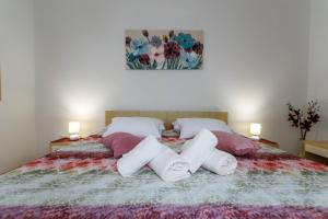 Postel nebo postele na pokoji v ubytování Apartments Paradiso
