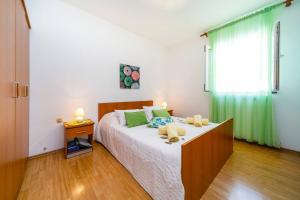 Postel nebo postele na pokoji v ubytování Apartments Paradiso