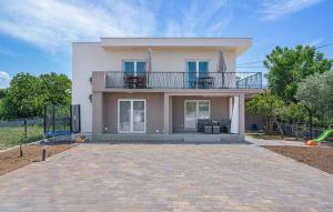 a large white house with a balcony and a playground at House Seaside Magnolias in Pirovac