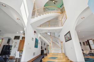 a spiral staircase in a home with white walls at The Starlight Tower Manor, River, Arcades, Observatory, Theater in Fort Atkinson