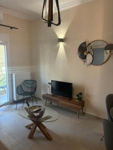 a living room with a tv and a coffee table at JD family luxury apartment 1 in Volos