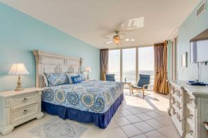 a bedroom with a bed and a view of the ocean at Vibrant Navarre Condo Pool and Beach Chair Service! in Navarre +25 photos