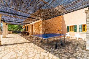 a ping pong table in the middle of a patio at Finca Casa BINITAREF in Sineu