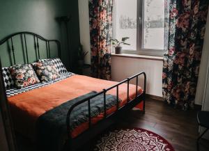a bedroom with a bed and a window with curtains at IKnamai in Sakiniai