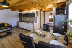 a kitchen and dining room with a table and chairs at Villa Alexandra in Bešeňová