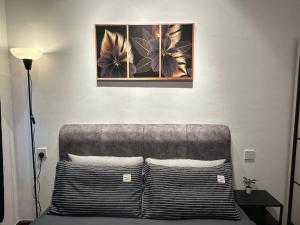 a bedroom with a couch with two pictures on the wall at Central Park 2 Bedrooms in Johor Bahru +133 photos