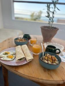 a table with a breakfast of eggs and toast at Sun & Sea Lodge Ocean roof in Essaouira +71 photos