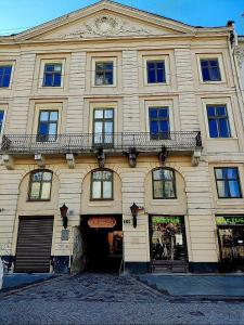 a large building with a balcony on top of it at "M&D ApartmentsLviv" Ultra Lux Rynok Square, 6person in Lviv