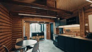 a kitchen with a table and chairs in a room at Sky Lodging - sleeping under the stars - private cottage in Rovaniemi