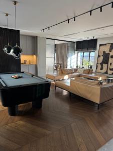 a living room with a pool table and a couch at Modern Vero Apartments Portova in Gdynia