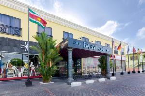 a building with a sign that reads hotel baratown at Hotel Babylon in Paramaribo