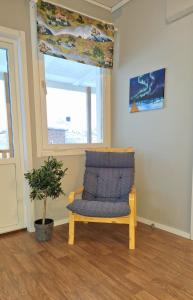 a chair sitting in a room with a window at Kuttainen Lodge in Karesuando