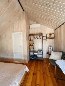 a bedroom with a bed and a table and a window at Долина ХЮГГЕ in Chornomors'ke +71 photos