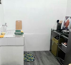 a small kitchen with a refrigerator and a table at Fully-furnished House Near Puan, Bago & Baliok in Davao City in Davao City +4 photos