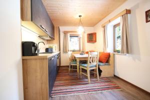 a small kitchen with a table and chairs in a tiny house at Almliesl GAST-719 in Bad Gastein