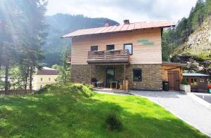 a house on a hill with a green lawn at Almliesl GAST-719 in Bad Gastein