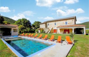 a villa with a swimming pool and orange chairs at Beautiful Home In Sauzet in Sauzet