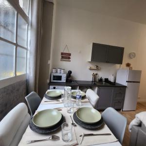 a kitchen with a table with chairs and a dining room at L'aT3lier d'Orthez in Orthez +11 photos