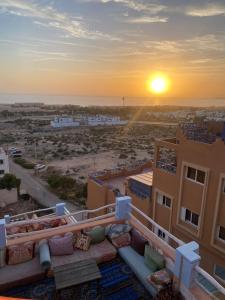 a view of the sunset from the balcony of a building at Terrasseplage appartement N9 in Tamraght Ouzdar