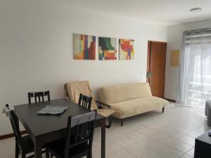 a living room with a table and a couch at Apartamento Santos in Ribeira Grande