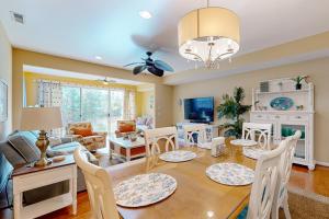 a dining room and living room with a table and chairs at Bayville Shores --- 35729 Coleman Ave in Selbyville