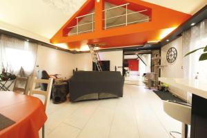 a living room with an orange ceiling and a room at Bretzel Home in Colmar +13 photos