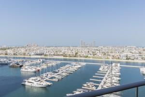 a group of boats docked in a harbor at Emerald at Tiara Beach Residences with Atlantis views in Dubai