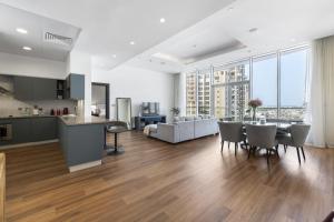 a kitchen and living room with a table and chairs at Emerald at Tiara Beach Residences with Atlantis views in Dubai