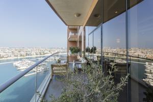 a balcony of a building with a view of the city at Emerald at Tiara Beach Residences with Atlantis views in Dubai