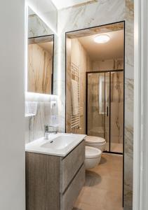 a bathroom with a sink and a toilet at Casa Fatmin in Tirrenia +35 photos