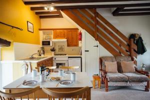a kitchen and dining room with a table and chairs at Barn Cottage - Family-Friendly Cottage with Heated Indoor Pool in Haverfordwest