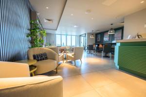 a waiting room with chairs and a table in a building at Polzeath Beach House in Polzeath