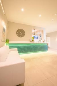 a living room with a clock on the wall at Polzeath Beach House in Polzeath