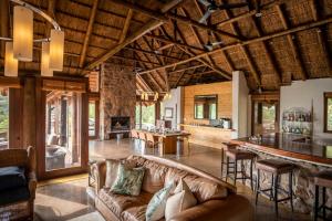 a living room with a couch and a bar at Tshwene Lodge in Vaalwater